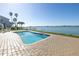 Community pool with brick paved patio and waterfront view at 800 Madonna Blvd # B, Tierra Verde, FL 33715