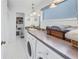 Convenient laundry room with washer, dryer, and counter space at 800 Madonna Blvd # B, Tierra Verde, FL 33715