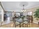 Dining area with glass-top table and chandelier at 800 Madonna Blvd # B, Tierra Verde, FL 33715