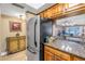 Kitchen with granite countertops, stainless steel appliances, and view to living area at 800 Madonna Blvd # B, Tierra Verde, FL 33715