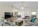 Bright living room featuring a sectional sofa, hardwood floors, and a dining area at 10823 Indian Hills Ct # 33, Seminole, FL 33777