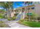 Well-maintained building exterior with stairs and landscaping at 10823 Indian Hills Ct # 33, Seminole, FL 33777