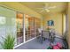 Spacious screened balcony with leafy views and access to dining area at 10823 Indian Hills Ct # 33, Seminole, FL 33777