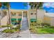 Well-maintained condo building with lush landscaping and private entrance at 10823 Indian Hills Ct # 33, Seminole, FL 33777