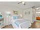 Bedroom with light walls, ceiling fan and wood flooring at 10823 Indian Hills Ct # 33, Seminole, FL 33777