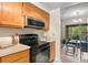 Well-equipped kitchen with modern appliances and wood cabinets at 10823 Indian Hills Ct # 33, Seminole, FL 33777