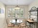 Bright dining area with glass top table and window views at 10823 Indian Hills Ct # 33, Seminole, FL 33777
