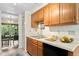 Clean kitchen featuring wood cabinets, double sink, and dishwasher at 10823 Indian Hills Ct # 33, Seminole, FL 33777