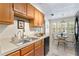 Kitchen features wood cabinets, double sink, and a breakfast area at 10823 Indian Hills Ct # 33, Seminole, FL 33777