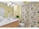 Clean bathroom with light yellow walls and a floral shower curtain at 10823 Indian Hills Ct # 33, Seminole, FL 33777