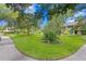 Landscaped community grounds with lush lawns and mature trees at 10823 Indian Hills Ct # 33, Seminole, FL 33777