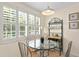 Small dining area with glass-top table and wine rack at 10823 Indian Hills Ct # 33, Seminole, FL 33777