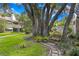 Brick pathway winds through a lush green community garden at 10823 Indian Hills Ct # 33, Seminole, FL 33777