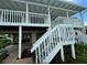 Elevated home with covered patio, stairs, and waterfront access at 15529 Redington Dr, Redington Beach, FL 33708