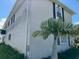 Side view of a light-beige two-story house with palm tree at 15529 Redington Dr, Redington Beach, FL 33708
