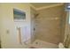 Tiled walk-in shower with built-in shelves, sleek fixtures, and neutral paint create a clean and inviting bathroom space at 1354 Azalea Dr # 1803, Dunedin, FL 34698