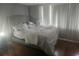 Simple bedroom with a bed and hardwood flooring at 7505 Pitch Pine Cir # 123, Tampa, FL 33617