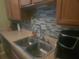 Kitchen with double sink and mosaic backsplash at 7505 Pitch Pine Cir # 123, Tampa, FL 33617