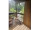 Screened porch with wooden chairs and partial plywood wall at 7505 Pitch Pine Cir # 123, Tampa, FL 33617