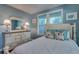 Cozy bedroom with a bed and dresser at 18 Heilwood St, Clearwater Beach, FL 33767