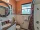 Bathroom with granite vanity and tiled shower at 18 Heilwood St, Clearwater Beach, FL 33767