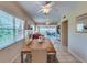 Bright dining area with wood table and seating for six, open to living room at 18 Heilwood St, Clearwater Beach, FL 33767