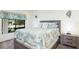 Bedroom with a queen-size bed and wood nightstand at 1354 Azalea Dr # 1803, Dunedin, FL 34698