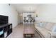 Living room with a sofa, coffee table, and view of kitchen at 1354 Azalea Dr # 1803, Dunedin, FL 34698