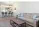 Living room with a sofa, coffee table and view of kitchen at 1354 Azalea Dr # 1803, Dunedin, FL 34698