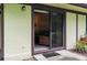 Sliding glass door opens to a small patio at 1354 Azalea Dr # 1803, Dunedin, FL 34698