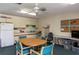 Simple kitchen in community room with table and chairs at 1354 Azalea Dr # 1803, Dunedin, FL 34698