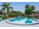 Relaxing community pool with surrounding patio furniture at 1354 Azalea Dr # 1803, Dunedin, FL 34698