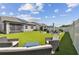 Spacious backyard with artificial turf and a seating area at 9309 Rally Spring Loop, Wesley Chapel, FL 33545