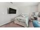 Bright bedroom with a TV, a vanity, and a comfortable bed at 9309 Rally Spring Loop, Wesley Chapel, FL 33545