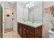 Double vanity bathroom with a large mirror and plenty of storage at 9309 Rally Spring Loop, Wesley Chapel, FL 33545