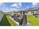 Spacious backyard with artificial turf, grilling station, and patio furniture at 9309 Rally Spring Loop, Wesley Chapel, FL 33545