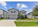 Two-story home with a two-car garage and landscaped front yard at 9309 Rally Spring Loop, Wesley Chapel, FL 33545