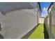 Landscaped side yard with artificial turf and privacy fence at 9309 Rally Spring Loop, Wesley Chapel, FL 33545
