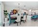 Bright dining room with modern chandelier and kitchen views at 9309 Rally Spring Loop, Wesley Chapel, FL 33545