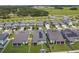 Aerial view of houses with solar panels and green lawns at 9309 Rally Spring Loop, Wesley Chapel, FL 33545