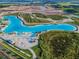 Expansive aerial view of crystal-blue lagoon pool at 9309 Rally Spring Loop, Wesley Chapel, FL 33545