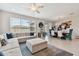 Spacious living room with sectional sofa and large windows at 9309 Rally Spring Loop, Wesley Chapel, FL 33545