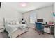 Bedroom with a queen bed, desk, and window with blinds at 9309 Rally Spring Loop, Wesley Chapel, FL 33545