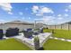 Artificial turf backyard with patio and seating area at 9309 Rally Spring Loop, Wesley Chapel, FL 33545