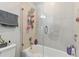 Bathroom with shower/tub combo, glass enclosure, and storage at 9309 Rally Spring Loop, Wesley Chapel, FL 33545