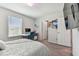Bedroom with a queen bed, desk, and window with blinds at 9309 Rally Spring Loop, Wesley Chapel, FL 33545
