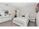 Bright bedroom with white furniture and en-suite bathroom at 9309 Rally Spring Loop, Wesley Chapel, FL 33545