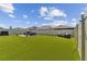 Artificial turf backyard with seating area and plenty of green space at 9309 Rally Spring Loop, Wesley Chapel, FL 33545