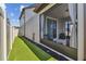 Cozy screened patio with seating area adjacent to grassy backyard at 9309 Rally Spring Loop, Wesley Chapel, FL 33545