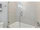 Bathroom with a shower/tub combo and glass enclosure at 9309 Rally Spring Loop, Wesley Chapel, FL 33545